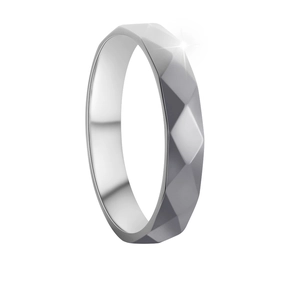 Close-up of a 4mm silver geometric ring with honeycomb faceted surface and polished finish