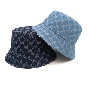 Monogram denim bucket hats in dark and light blue with all-over letter pattern