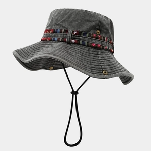 Close-up of grey washed denim bucket hat with ethnic woven band and adjustable wind cord