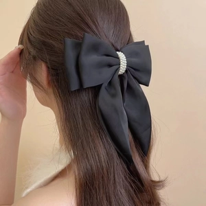 Elegant oversized black satin bow hair clip with white pearl center for women