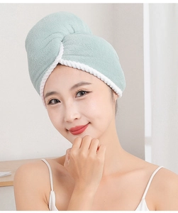 Detail of mint green dual-layer microfiber hair towel wrap shown on a model