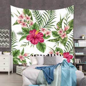 Detail of bohemian tropical tapestry with red hibiscus and green palm leaves in bedroom