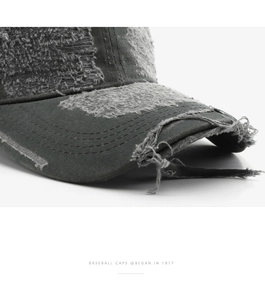 Macro shot of distressed grey denim baseball cap with vintage worn-out details
