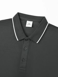 Detail of dark grey polo shirt collar featuring pique fabric texture and three buttons