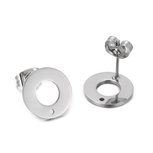 Detail view of silver stainless steel round stud earrings with small holes and butterfly backs