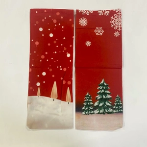 Detail of red Christmas bottle covers with printed snowflakes and holiday patterns
