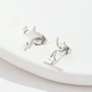 Macro shot of silver asymmetric star stud earrings on a white frosted display stand