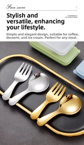 Detailed view of silver and gold stainless steel short spoons and forks on a black tray