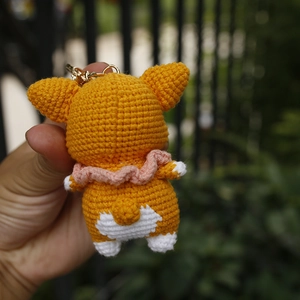 Handmade crochet Corgi dog keychain with orange yarn and metal ring back view
