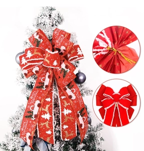 Detail of red Christmas tree topper bow with truck print and golden twist ties
