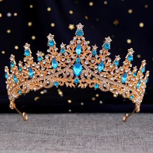 Golden bridal crown with blue crystals and white rhinestones on star background