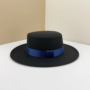 Elegant black flat-top boater hat with a navy grosgrain ribbon and a bow detail