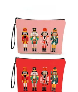 Detailed view of pink and red Nutcracker canvas makeup bags with zip and lanyard