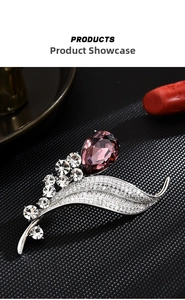 Macro shot of silver leaf brooch with purple teardrop crystal and shimmering diamonds