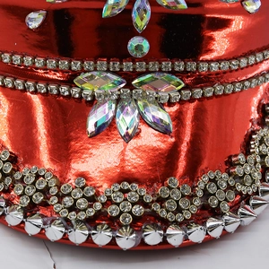 Detailed macro view of punk red captain hat with rhinestones, gems and silver studs