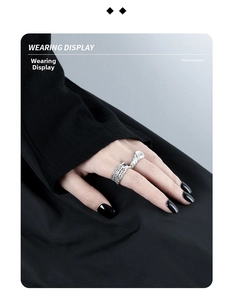 Wearing display of vintage textured silver rings featuring blue gem and zircon accents