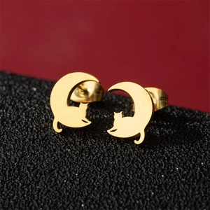 Minimalist stainless steel gold cat and moon stud earrings on premium black display stand