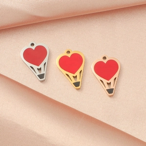 Mirror polished heart balloon pendants in silver gold and rose gold on pink silk fabric