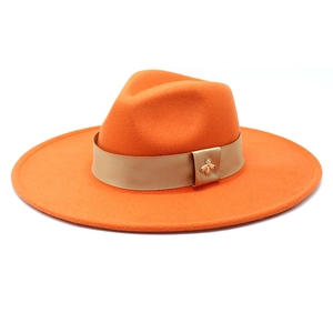 Orange wide-brim wool fedora hat with gold bee buckle and satin band decoration
