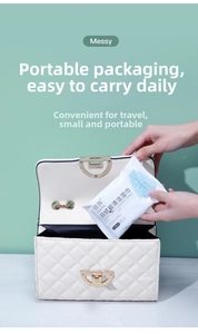 Portable down jacket cleaning wipes being placed in a stylish quilted chain handbag