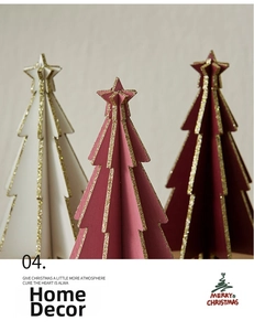 Detailed view of three mini wooden Christmas trees with gold glitter edges for tabletop decor