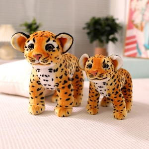 Cute realistic leopard plush toy duo with soft orange spotted fur on white bedding