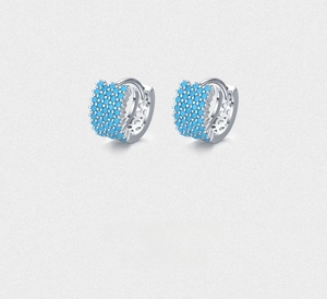 Detail view of S925 sterling silver hoop earrings with paved turquoise stones