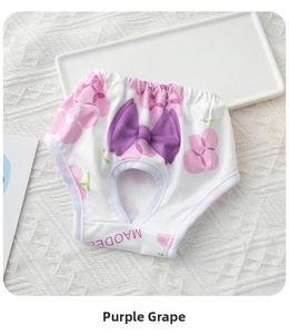 Detail view of cotton dog sanitary pants with purple grape print and decorative bow