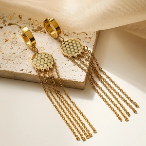 Elegant gold Tree of Life tassel earrings displayed on a natural stone surface