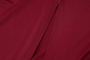 Close-up of high-quality sewing craftsmanship on a burgundy side slit sleeveless dress