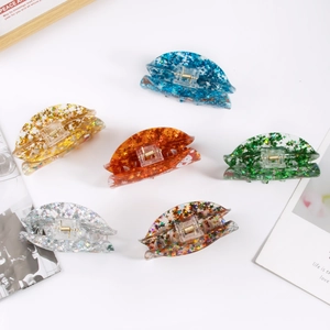 Set of 6 colorful Christmas hair claws with glitter stars and snowflakes inside