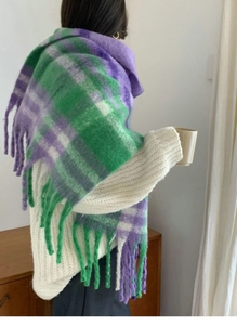 Detail of purple and green plaid scarf featuring soft mohair texture and thick tassel edges