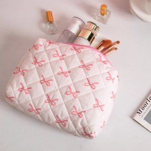 Quilted pink makeup bag with bow pattern and large capacity for travel toiletries