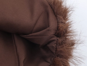 Detailed close-up showing the brown faux fur texture and fabric lining of the winter coat
