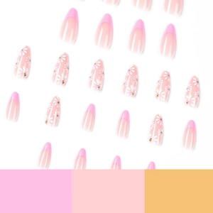 Glossy press-on nails with pink French tips and daisy patterns on a white background