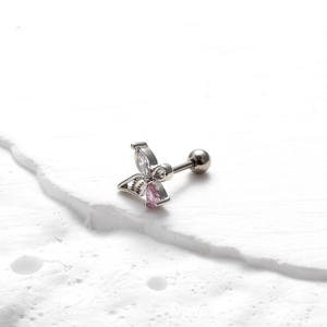 Macro detail of butterfly ear stud with pink zircon and screw back on stone base