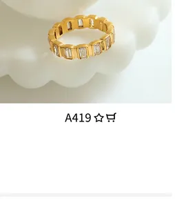 Close-up of 18K gold plated baguette-cut cubic zirconia eternity ring on a tray
