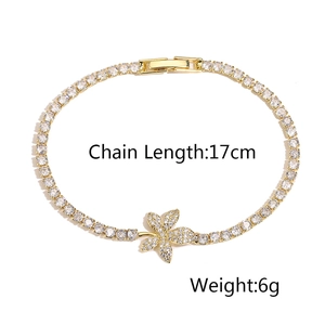 Detailed view of a gold tennis bracelet featuring sparkling zircon flower charms and chain