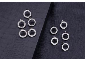 Macro shot of silver circular earrings featuring micro-pave white cubic zirconia stones