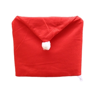 Festive red velvet Christmas hat chair cover with white plush pompom for party decor