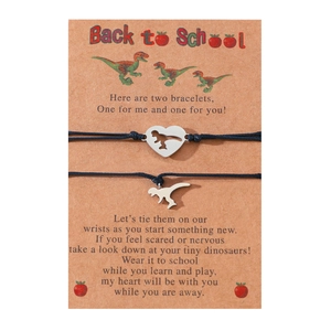 Detail of two dinosaur bracelets on Back to School card with black woven cord