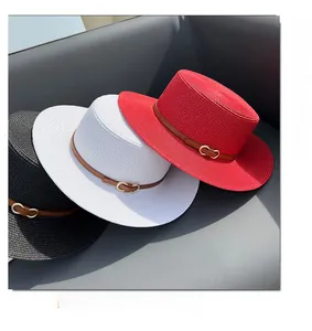 Three boater straw hats in black, white, and red with leather bands and gold horsebits