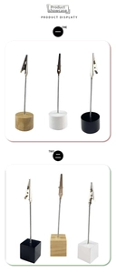 Close-up of wooden memo holders with metal alligator clips in round and cubic shapes
