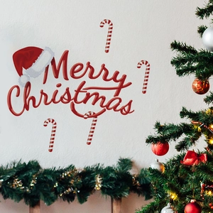 Detail view of Merry Christmas wall stickers with red candy canes and a festive hat