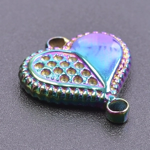Macro shot of rainbow heart pendant with honeycomb texture and beaded edge detail
