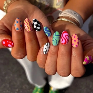 Colorful long almond press-on nails with checkerboard, zebra, and wave patterns