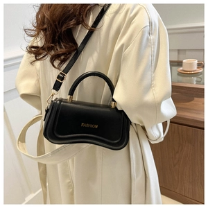 Close-up of black PU leather handbag with unique wavy bottom and gold FASHION lettering