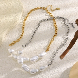 Detailed macro view of artificial Baroque pearls and 18K gold-plated metal chain necklace