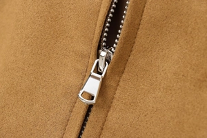 Close-up of camel suede jacket texture with premium silver metal zipper detail