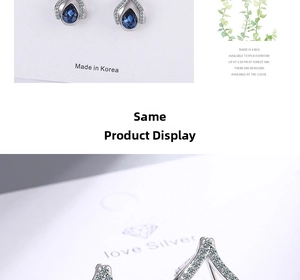 Detailed close-up of teardrop dark blue crystal earrings with zircon inlay in silver setting
